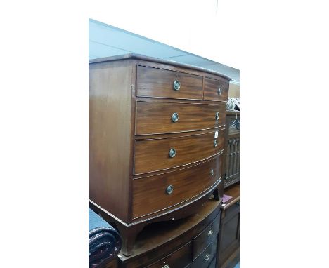 19th century mahogany bow front chest of two short and three long drawers with brass ring handles, on bracket feet