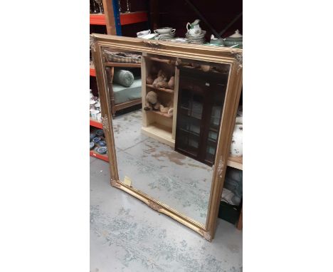 Large bevelled wall mirror in ornate gilt frame