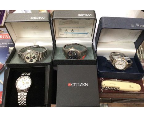 Three Seiko stainless steel wristwatches and one Citizen, all boxed, two Victorinox Swiss Army knives, both new, and a Ranger