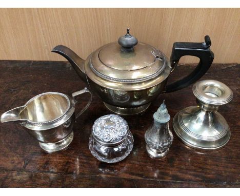 Silver tea pot, silver cream jug, small silver candlestick, silver caster and silver topped glass jar