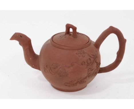 A Staffordshire redware miniature teapot and cover, circa 1760, of round shape, with crabstock handle and spout, sprigged fol