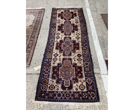 Persian runner, with four concentric medallions on biscuit ground in main flowerhead border, 269 x 90cmPatch repair towards o