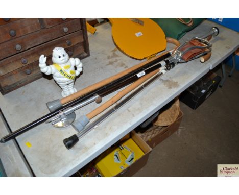 A Comara mono pod walking stick; and three other various walking sticks 