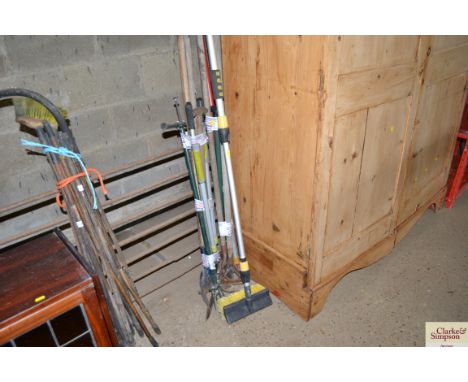 A quantity of long handled tools and a brush