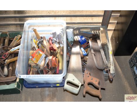 Two boxes of tools, including slashers, saws etc.