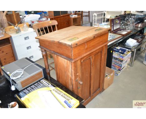 A large pine desk together with an elm seated stick back chair
