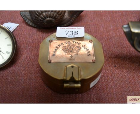 A reproduction brass cased compass