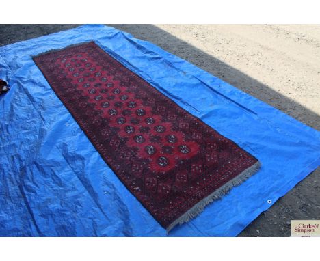 An approx 9'6" x 2'10" red Eastern patterned runner