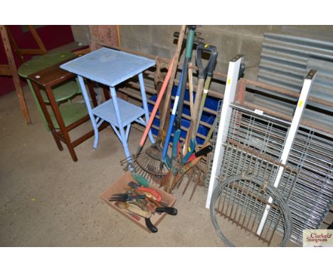 A quantity of long handled and short handled garden tools