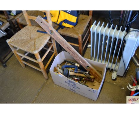 A box of tools including a long level 