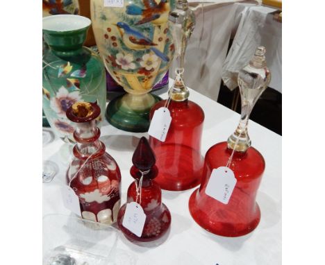 A ruby flashed glass decanter, two cranberry glass bells and two other items (5) 