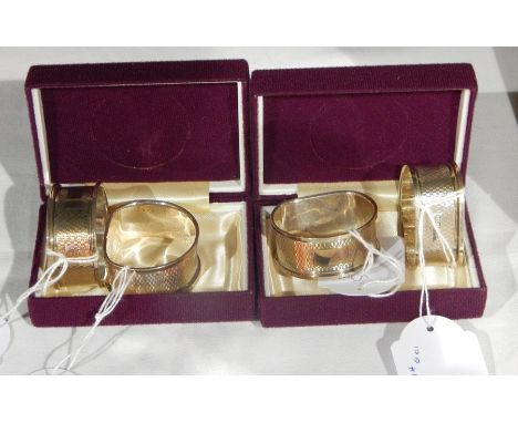 A pair of silver engine turned napkin rings, Birmingham 1979 together with another pair of the same date, boxed  