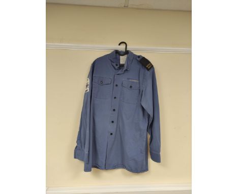 British Royal Navy uniform, a blue cotton shirt "Man's Working Dress" with ROYAL NAVY epaulette slides and MW (Mine Warfare) 