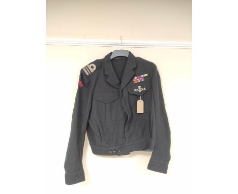 British Royal Navy uniform, a black jacket having RN AUXILIARY SERVICE cloth shoulder patches, RNXS breast badge, epaulette r