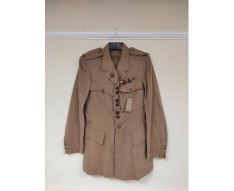 British Army uniform, a light stone summer jacket having with "J N AGNEW" label, leather knot buttons, epaulette rank insigni