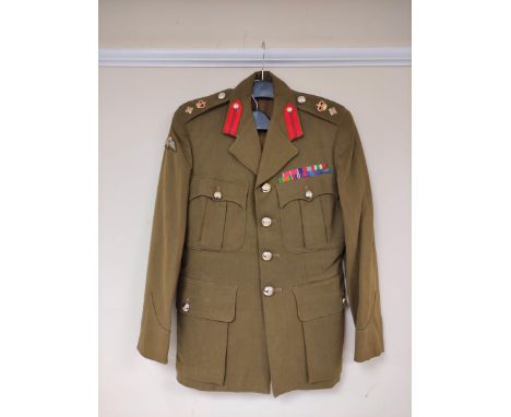 British Army uniform, an olive green jacket having Royal Artillery staybrite buttons, epaulette rank insignia for the rank of