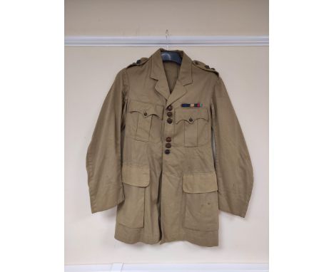 British Army uniform, a light stone summer jacket having leather knot buttons, epaulette rank insignia for the rank of Captai