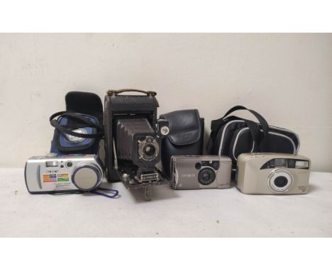 Camera lot to include three digital cameras including a Minolta Vetis 20, Sony Cybershot and an early Kodak folding camera (4