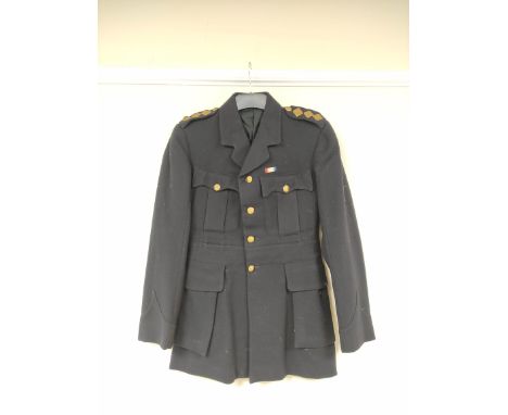 British Army uniform, a dark blue jacket having Dorsetshire Regiment brass buttons, epaulette rank insignia for the rank of C