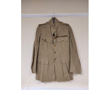 British Army uniform, a light stone summer jacket having Daniels and Co of Woolwich Royal Artillery brass buttons, epaulette 