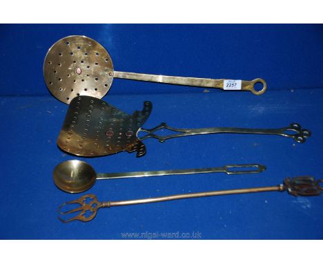 Two brass skimmers, a toasting fork and a small ladle.