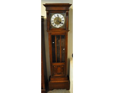 Mid Century oak three train longcase clock with silver dial and Roman numerals with key and pendulum.(B.P. 21% + VAT) 