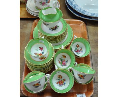 Printed and painted part teaware florally decorated and edged with green and gold comprising: 12 side plates and 2 large plat