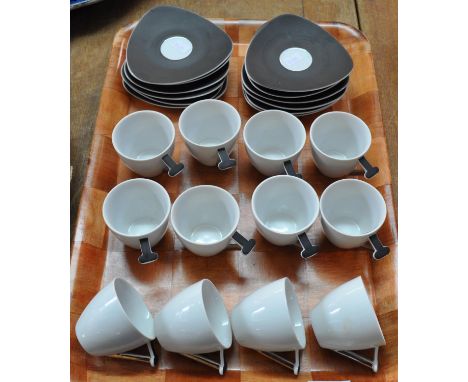 Twelve small Thun Studio Czechoslovakian coffee cups and saucers in brown and white with silver handles topped with a 'T'.(B.