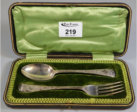 Cased christening set comprising; fork and spoon with chased decoration, 2.2 troy ozs approx, in fitted original velvet case.