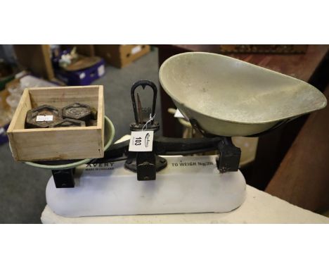 A pair of Avery cast iron and enamelled scales with brass pans and assorted weights.(B.P. 21% + VAT) 