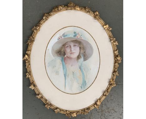 An early 20th century watercolour portrait of a women in a white hat, signed R. Ponnet lower right, in an oval giltwood frame