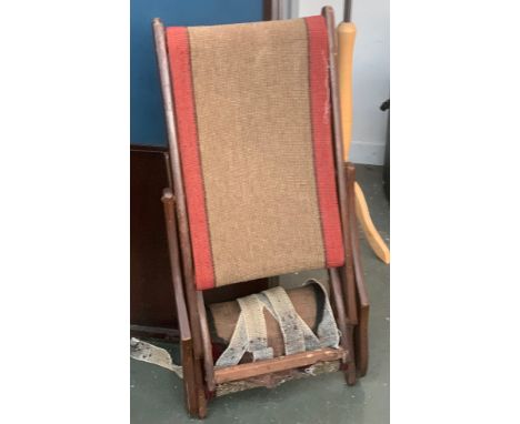 A vintage folding chair, in need of repair 