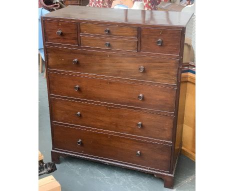 An early 20th century Heal's mahogany chest of drawers, with two small central drawers flanked by two deeper, over four long 
