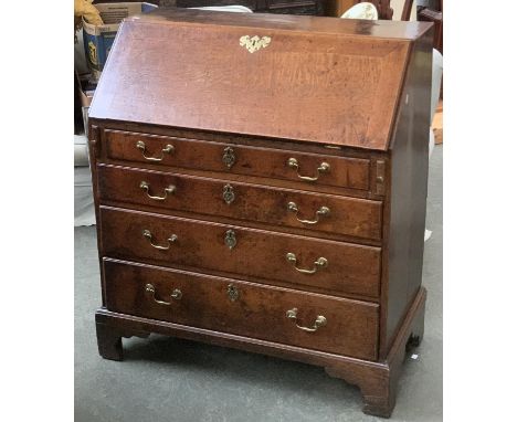 A George III oak bureau, fall front opening to a fitted interior, over four graduated drawers, on bracket feet, 92cmW 