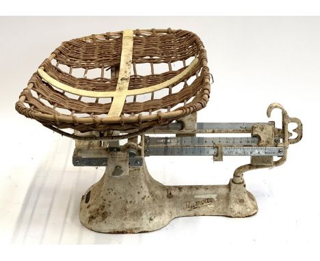 A set of vintage Harrods baby weighing scales with wicker basket 