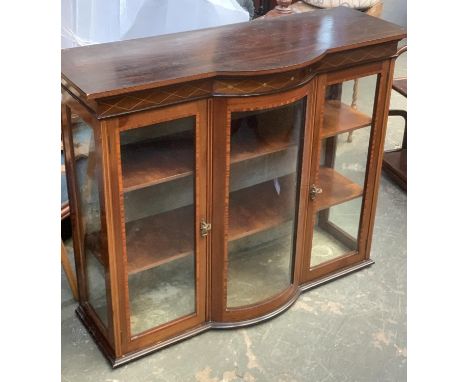 An Edwardian glazed cabinet, central bowfront glazed panel, flanked by two cupboards, 114x43x94cmH 