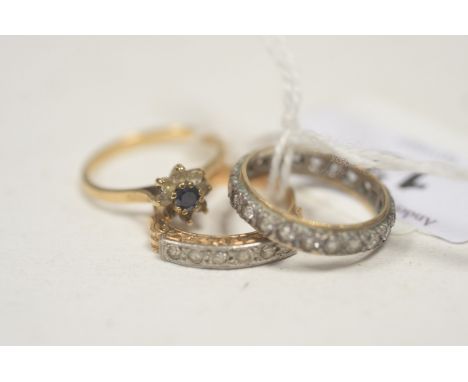 A French 19th Century six white stone set ring, with leaf decorated scrolling mount; a white stone set eternity ring stamped 