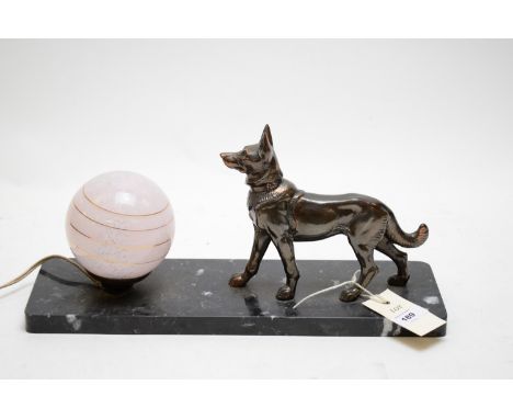 An Art Deco table lamp with patinated metal Alsatian figure by Pink Glass Globe shade, on black marble base, 38cms wide.