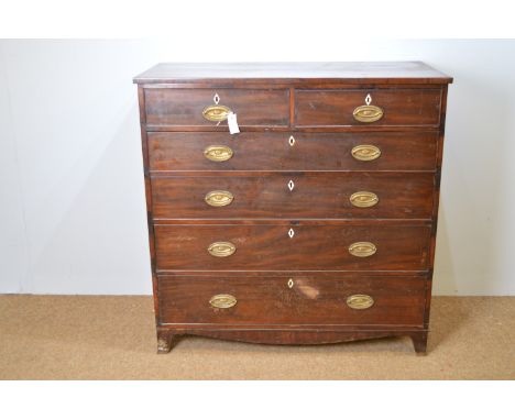 A George III mahogany chest of two short and four long graduated drawers with oval brass handles, bracket feet, 117 x 57 x 11