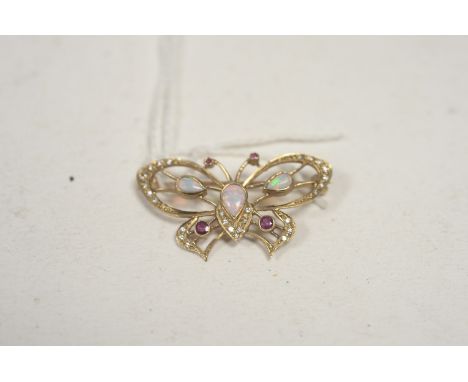 A 9ct. yellow gold ruby, opal and diamond set butterfly pattern brooch, the body and wings set with tear-cut cabochon opals, 