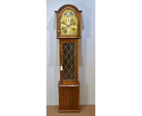 Fenclocks, Suffolk: a modern oak longcase clock, the brassed roman moon phase dial with lever for Westminster, St. Michael, W