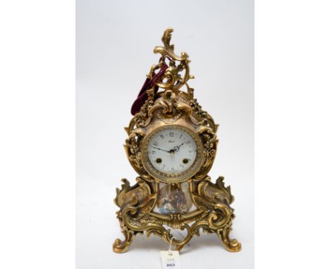 A modern French style Mozer metal cased mantel clock in rococo design, 44cms high, the movement striking on two bells.