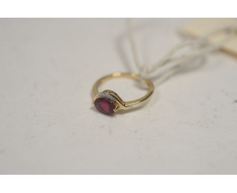 A rubellite and diamond ring, the oval facet cut rubellite set beside five brilliant-cut diamonds, on 9ct. yellow gold shank,