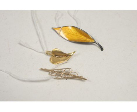 A 9ct. yellow gold spiral pattern brooch; a 9ct. yellow gold leaf pattern brooch, 9.2g gross; and a Norwegian silver and oran