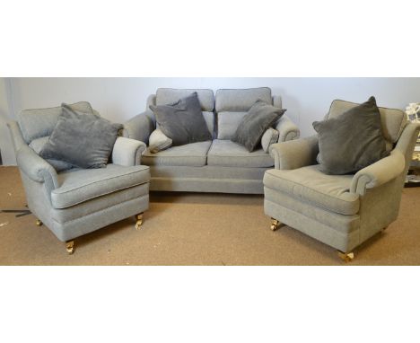 A modern grey upholstered three-piece lounge suite, comprising: two-seater sofa and two armchairs, each raised on squat taper