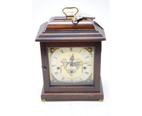 A modern mahogany cased mantel clock with brass roman dial, retailed by Comitti, London, fitted a Westminster chiming movemen