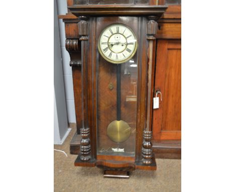 An early 20th Century walnut cased Vienna style wall clock, with white enamel roman dial and subsidiary seconds aperture, 96c