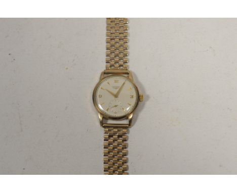 A 9ct. yellow gold cased Longines wristwatch, the arabic/triangular baton dial with subsidiary seconds aperture, fitted manua