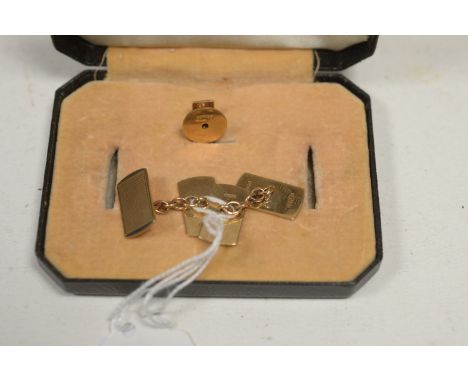 A pair of 9ct. yellow gold cufflinks with blank and textured plaque; together with a single shirt button, 6.8g gross.