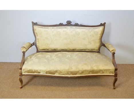 A late Victorian stained beechwood two-seater sofa, the shaped back with scroll and cabochon frieze, serpentine seats, on sle